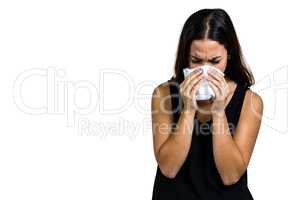 Unhappy woman blowing nose