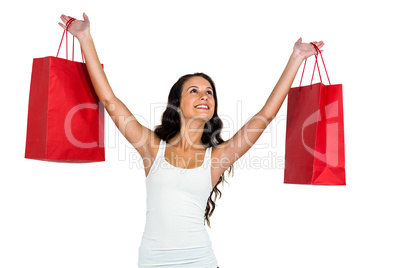 Smiling woman holding red shopping bags