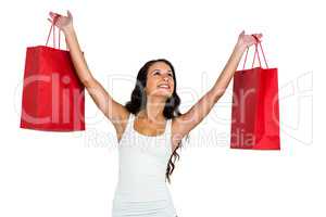 Smiling woman holding red shopping bags
