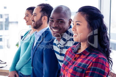 Portrait of cheerful businessman with colleagues