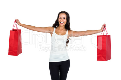 Smiling woman holding red shopping bags