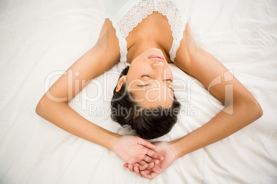 Brunette sleeping on the bed