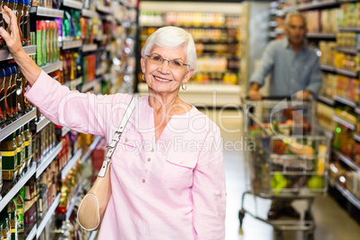 Senior woman picking out product
