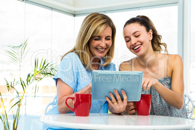 Mother and daughter watch tablet