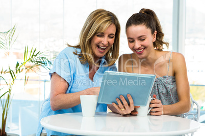 Mother and daughter watch tablet