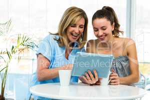 Mother and daughter watch tablet