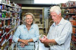 Smiling senior couple buying food