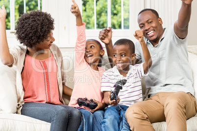 Smiling family sitting on the couch together