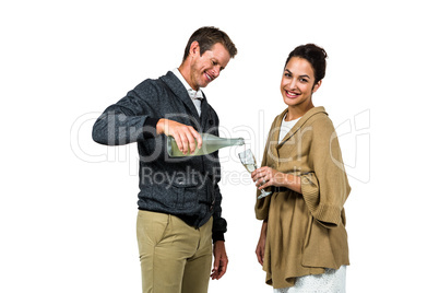 Man pouring wine in glass with woman