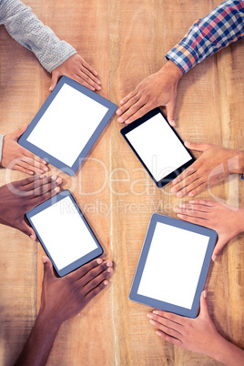 Business colleagues using digital tablet at desk