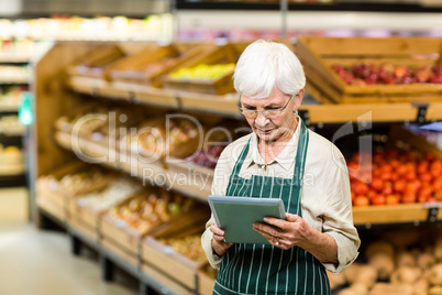 Senior employee working with tablet