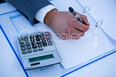 Close up view of desk with hands writing