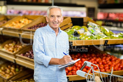 Smiling senior man with shopping list