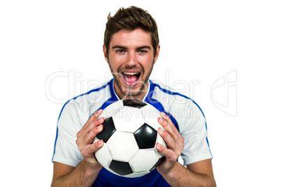 Portrait of man holding football with mouth open