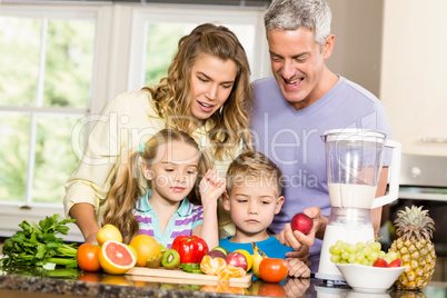 Happy family preparing healthy smoothie