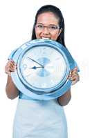 Delighted businesswoman holding a clock