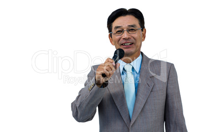 Asian businessman holding microphone