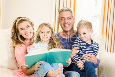 Happy parents reading to their kids