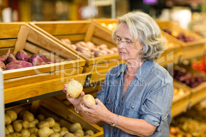 Senior woman holding potatoes