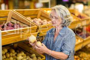 Senior woman holding potatoes