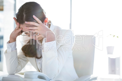 Stressed businesswoman working at her desk