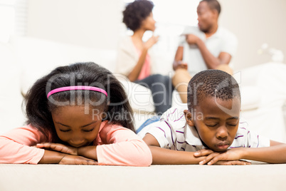 Unhappy kids lying on the floor