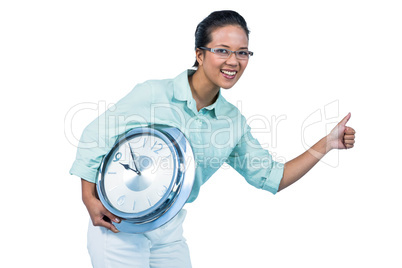 Delighted businesswoman holding a clock