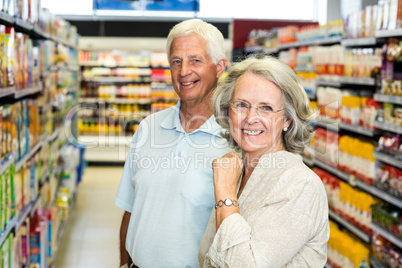 Smiling senior couple at the supermarket