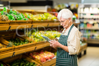 Senior employee working with tablet