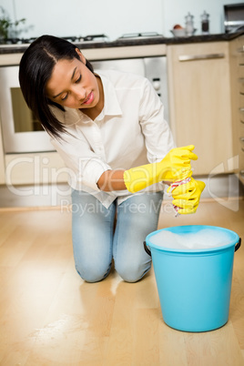 Attractive brunette cleaning the floor