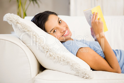 Smiling brunette reading book Smiling brunette reading book