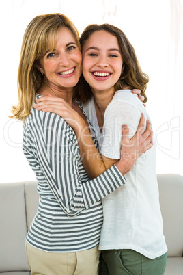 Mother and daughter hugging