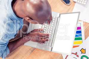High angle view of creative businessman working on laptop