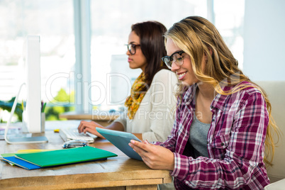 Two girls work at office