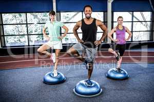 Fit people doing exercise with bosu ball