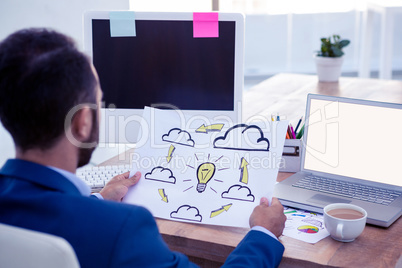 Professional looking at clouds and bulb drawn on paper