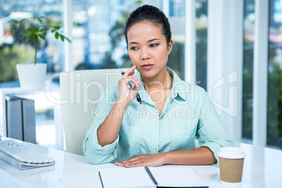 Thoughtful young businesswoman looking away