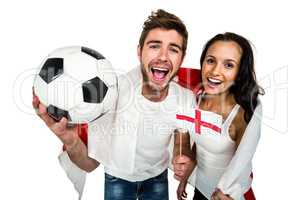 High angle view of couple holding football and English flag