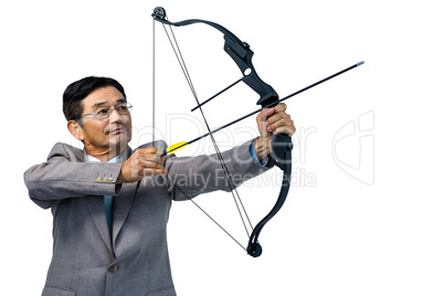 Focused businessman shooting a bow and arrow