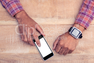 Man using smart phone on desk