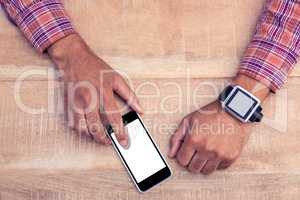 Man using smart phone on desk