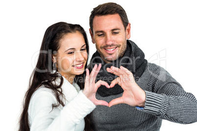 Smiling couple making heart shape with hands