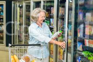 Smiling senior woman buying food