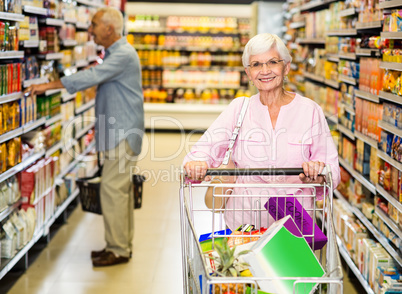 Senior woman pushing trolley