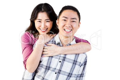 Smiling man gives girl a piggy back