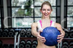 Smiling fit woman exercising with medicine ball