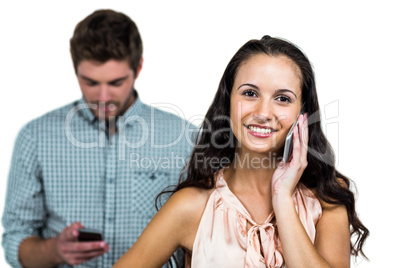 Happy couple using smartphones