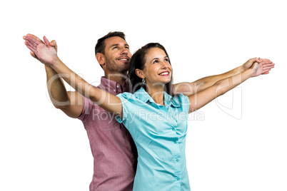Cheerful couple with arms outstretched