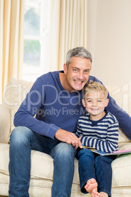 Father and son reading book