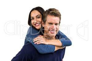 Portrait of cheerful man carrying girlfriend on back